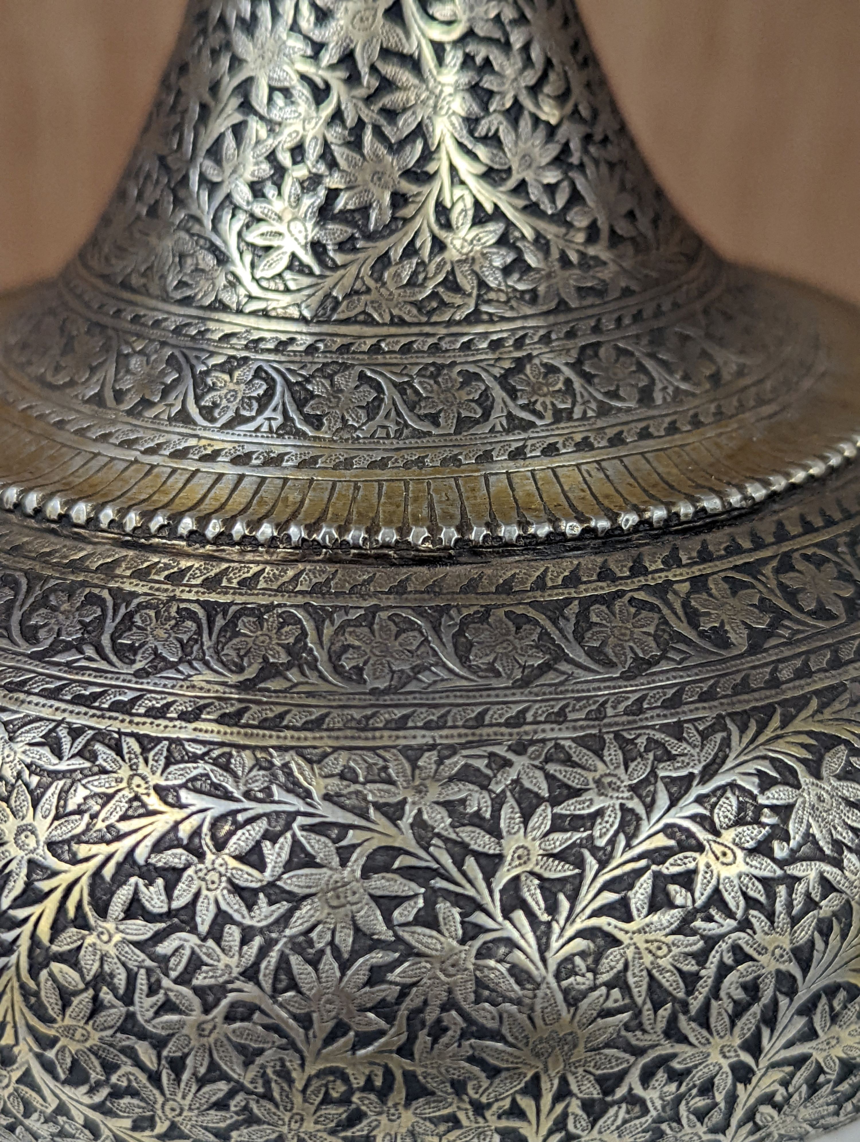 A 19th century North Indian silver surahi with engraved shawl decoration 30cm